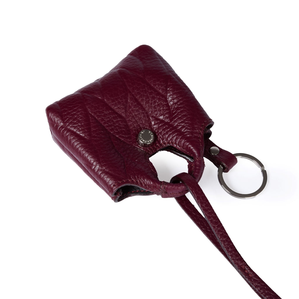 Porta air pods Alina charms in pelle stampa treccia con anella portachiavi