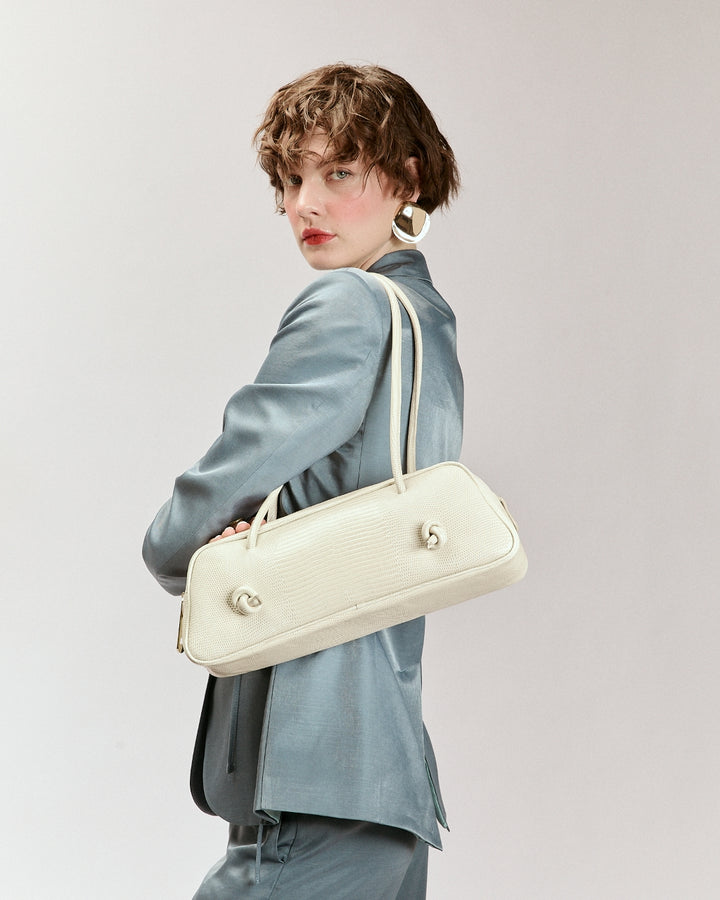 Grace Tejus – Elongated bag in glossy lizard-print calfskin